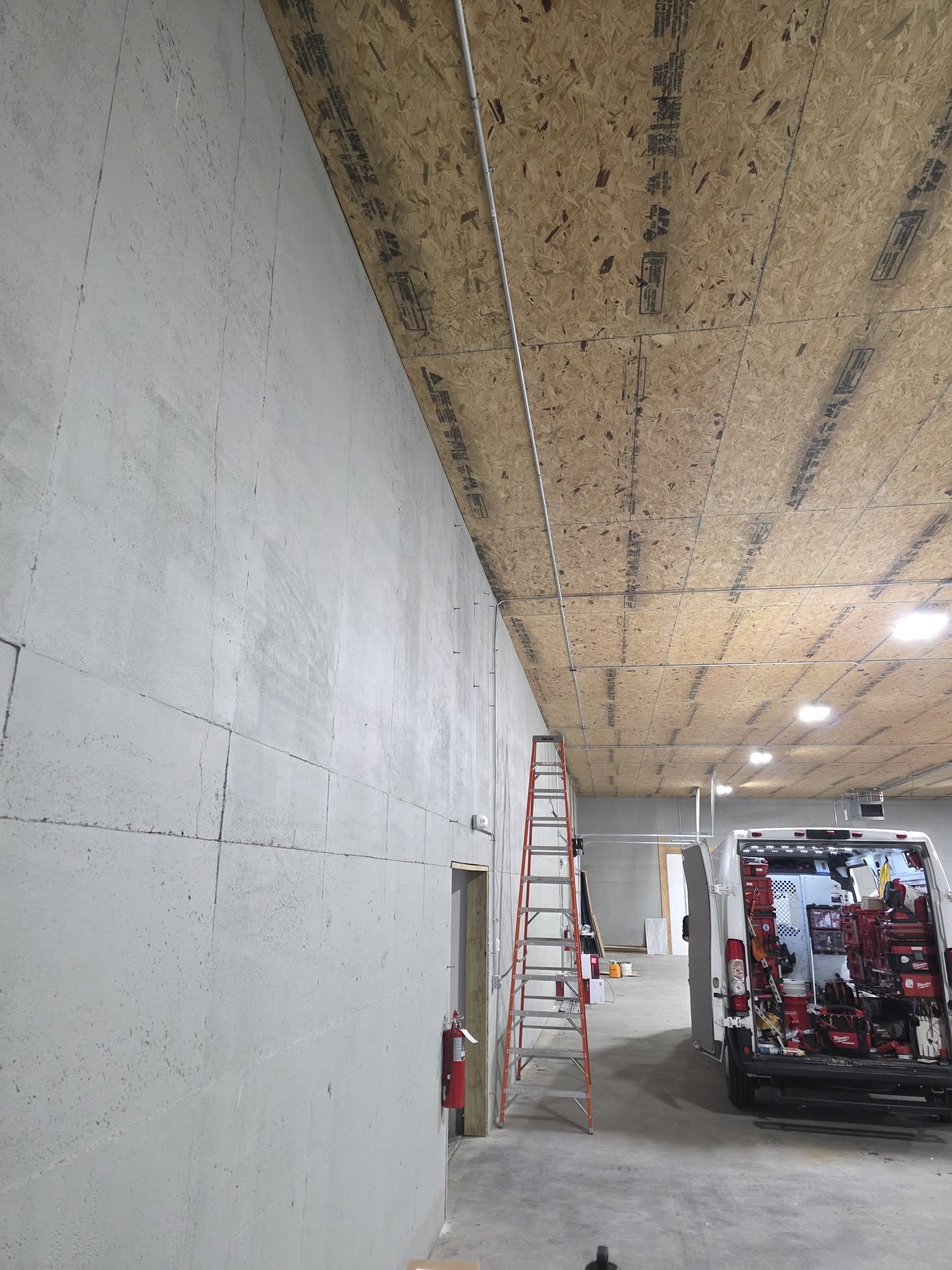 Wire-It van and ladder during commercial warehouse cabling deployment